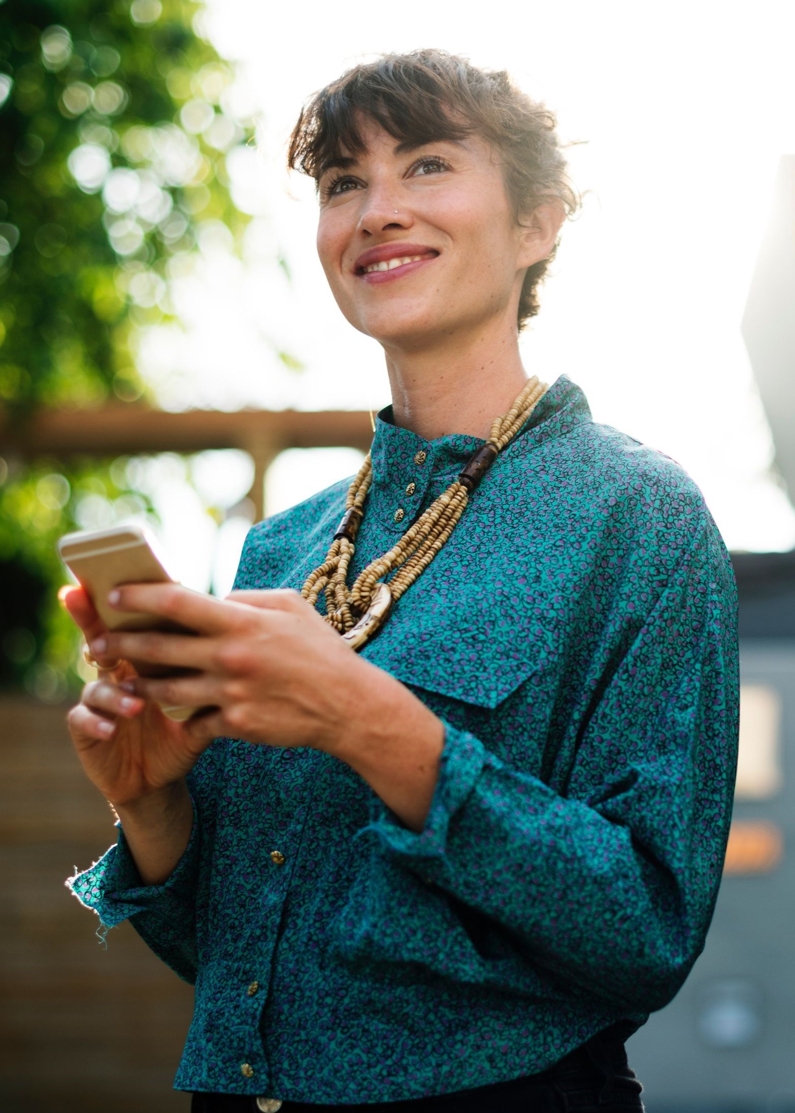 Adult smiling while holding phone